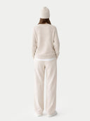 back view of a beige sweater and pants set with a white beanie on a white background#color_birch