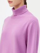 Close-up of a person wearing a light purple turtleneck sweater on a white background #color_fuchisa-pink