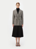 a gray double breasted blazer and black skirt #color_warm-grey