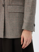 close up of a gray blazer sleeve #color_warm-grey