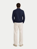 back view of a Person wearing a navy sweater and beige pants on a white background #color_navy