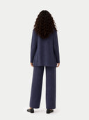 back view of a woman wearing a navy blue open cardigan matching with wide-leg cashmere pants on a white background #color_crown-blue