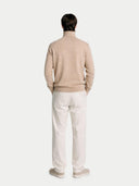 back view of a Man wearing a beige sweater and white pants on a white background #color_beige