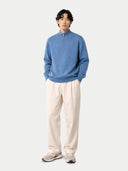 front view of a man wearing a blue sweater with a zipper on a light gray background color_blue