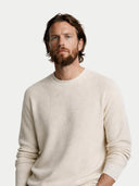 Man wearing a beige sweater against a white background #color_off-white