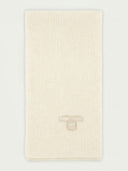 Beige ribbed blanket with a brand label on a light gray background #color_white