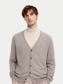 Man wearing a gray cardigan over a beige turtleneck on a light background #color_dawn-blue