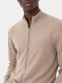 Beige zip-up sweater worn by a person on a light gray background #color_taupe