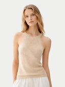Woman wearing a beige sleeveless top against a light background #color_beige