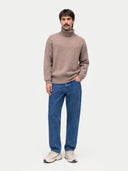 Man wearing a beige sweater and blue jeans on a white background #color_taupe