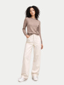 front view of a woman wearing a brown sweater and white pants on a white background #color_timber-wolf