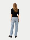 back view of light blue jeans and a black top on a white background #color_black