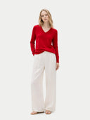 front view of a woman wearing a red sweater and white pants on a white background #color_chili-pepper