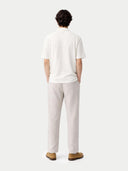 back view of a white t-shirt and light gray pants on a plain background #color_whisper-white