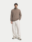 front view of a Man wearing a brown turtleneck sweater and white pants on a white background #color_taupe