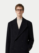 Man wearing a black coat and glasses on a white background #color_black