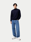 front view of a man wearing a navy sweater, blue jeans, and white sneakers on a white background #color_navy-blazer