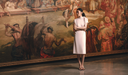 Woman in white cashmere midi dress standing in an art gallery — GOBI Spring–Summer 2026