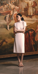 Woman in white cashmere midi dress standing in an art gallery — GOBI Spring–Summer 2026