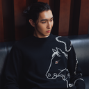 Man wearing black cashmere sweater with artistic horse print — GOBI Men Spring–Summer 2026