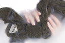 Brown scrunchies with a visible brand label on a white background
