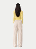 back view of a yellow top and beige pants on a white background #color_blazzing-yellow