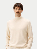 Man wearing a beige sweater against a white background #color_off-white