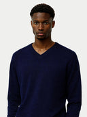 close up of a Man wearing a navy blue sweater against a plain background #color_navy