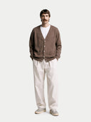Man wearing a brown cardigan, white shirt, and light-colored pants on a white background  #color_cocoa