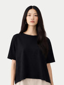 Woman wearing a black t-shirt against a white background #color_black