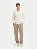 front view of a Man wearing a cream sweater and beige pants on a white background #color_marshmallow