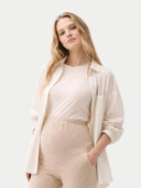 Woman wearing a beige outfit on a white background #color_beige