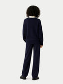 Person wearing a navy blue outfit on a white background #color_navy
