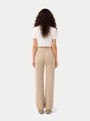 back view of a white top and beige pants on a white background #color_warm-grey