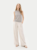 front view of a woman wearing a gray sleeveless sweater and beige wide-leg pants on a white background #color_dawn-blue
