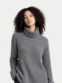 Woman wearing a gray turtleneck sweater on a light gray background #color_steel-gray