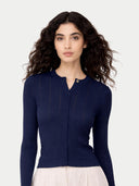 Woman wearing a navy blue cardigan against a white background #color_mood-indigo