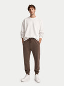 front view of a man wearing a white sweatshirt and brown pants on a white background #color_cocoa