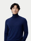 Man wearing a blue turtleneck sweater against a white background #color_mood-indigo
