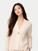 Woman wearing a cream-colored cardigan against a white background #color_off-white