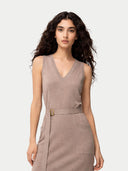Woman wearing a beige sleeveless dress with a belt on a white background #color_nomad