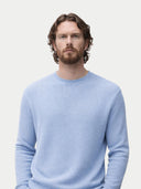 Man wearing a light blue sweater against a plain background #color_celestial-blue