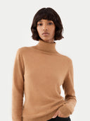 woman wearing an almond color turtleneck sweater. #color_sheepskin