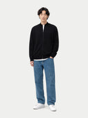 front view of a Person wearing a black zip-up sweater, blue jeans, and white sneakers on a white background #color_black