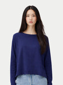 Woman wearing a blue sweater against a plain background #color_navy