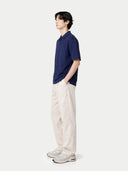 side view of a navy blue shirt and beige pants on a white background #color_navy