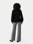 back view of  a black sweater and gray pants on a white background #color_dim-gray