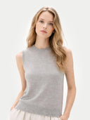 Woman wearing a gray sleeveless sweater against a white background #color_dawn-blue