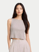 Woman wearing a gray sleeveless top and beige pants on a white background #color_dawn-blue