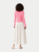 back view of a pink long-sleeve top and white skirt on a white background #color_shell-pink